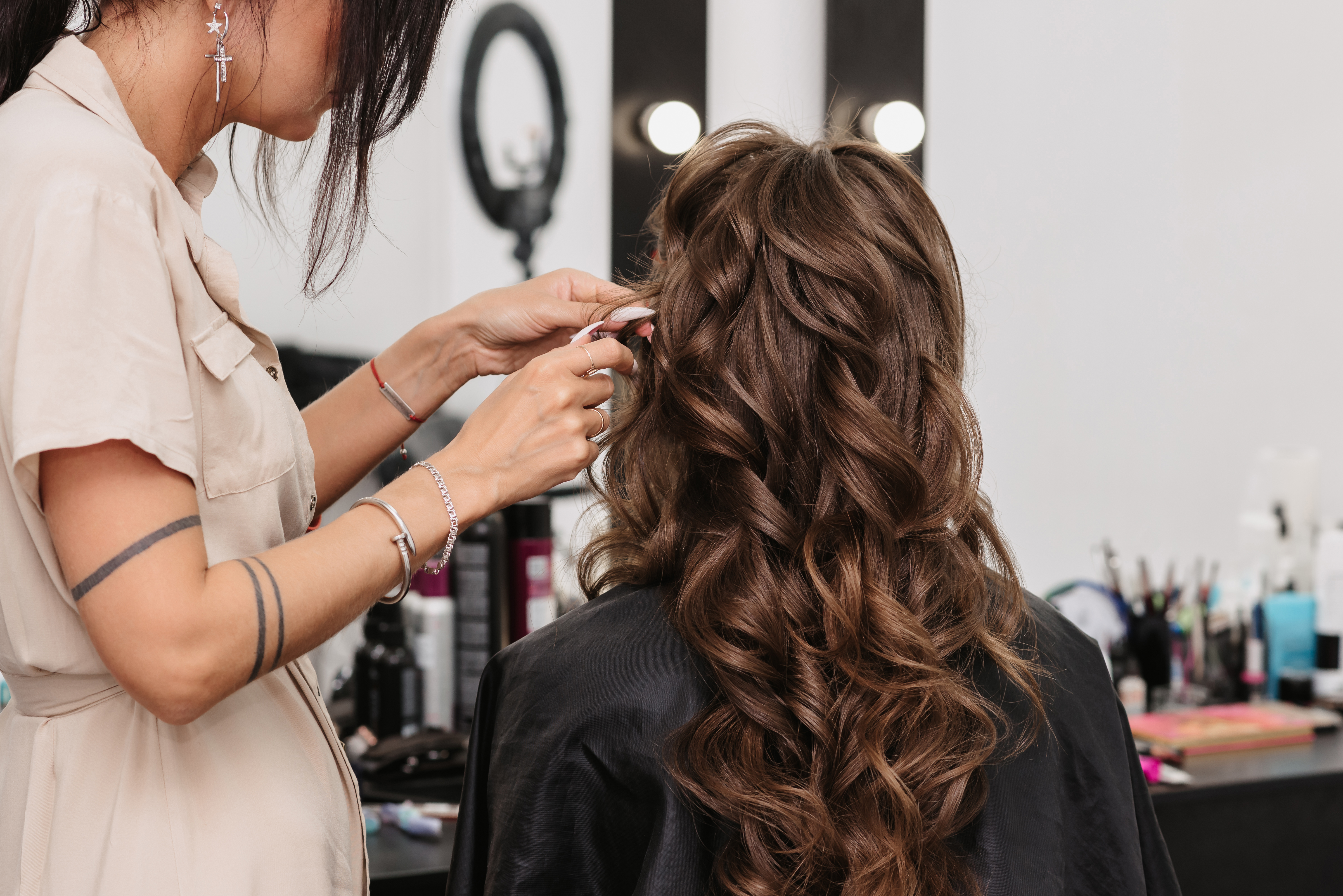 Hair stylist braiding curly hair