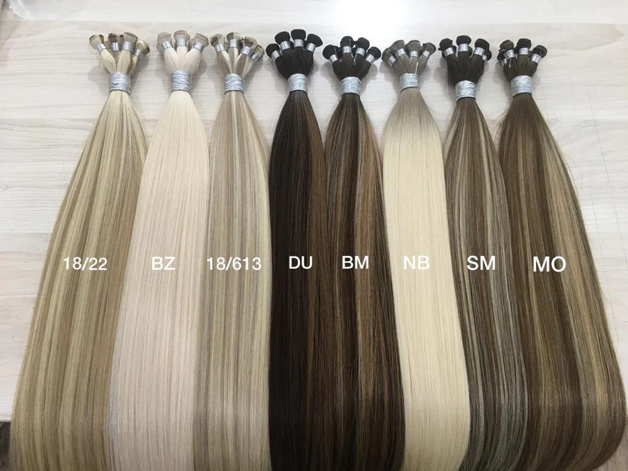 A row of eight bundles of straight hair extensions