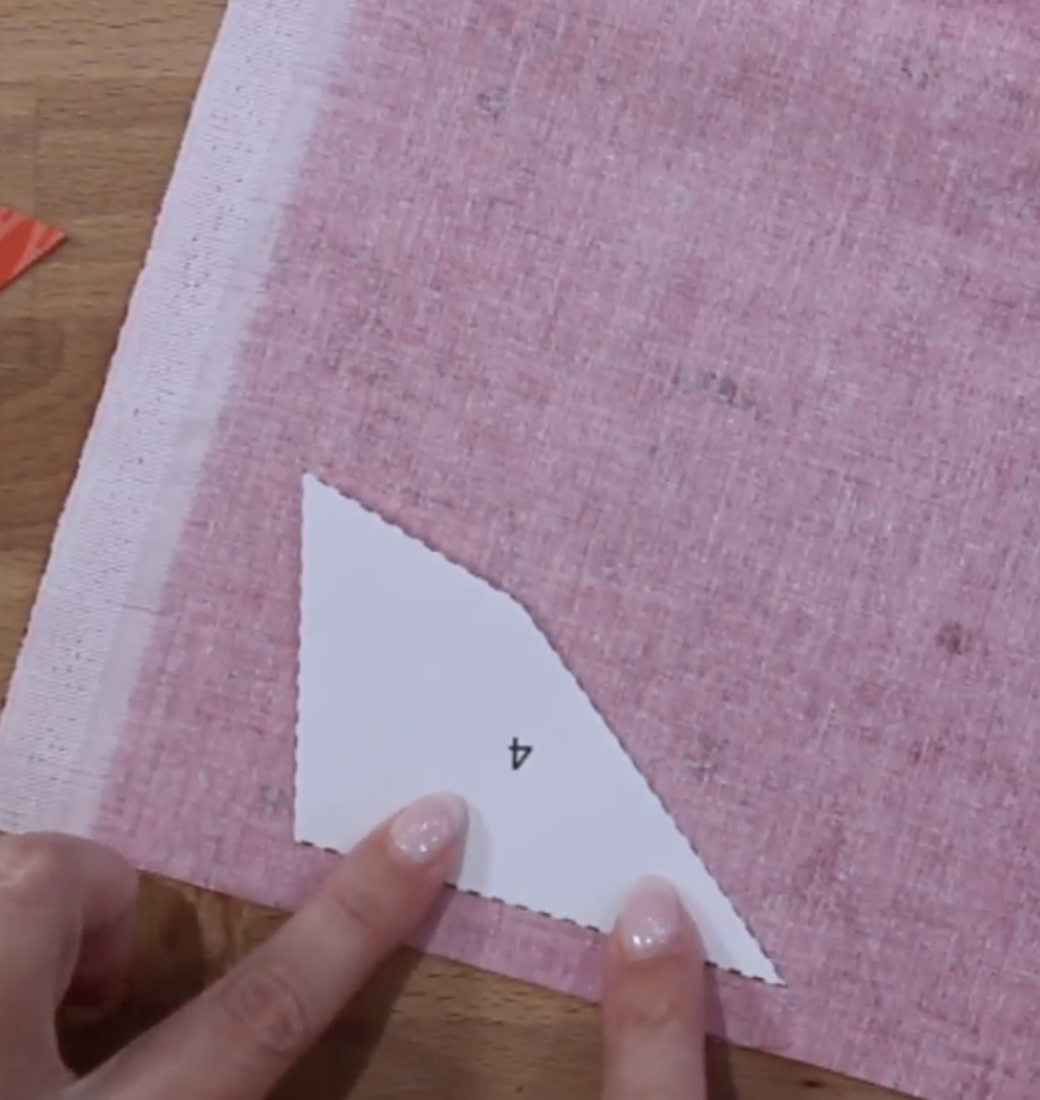 Place wrong side of the template (waxy side) to the wrong side of the fabric