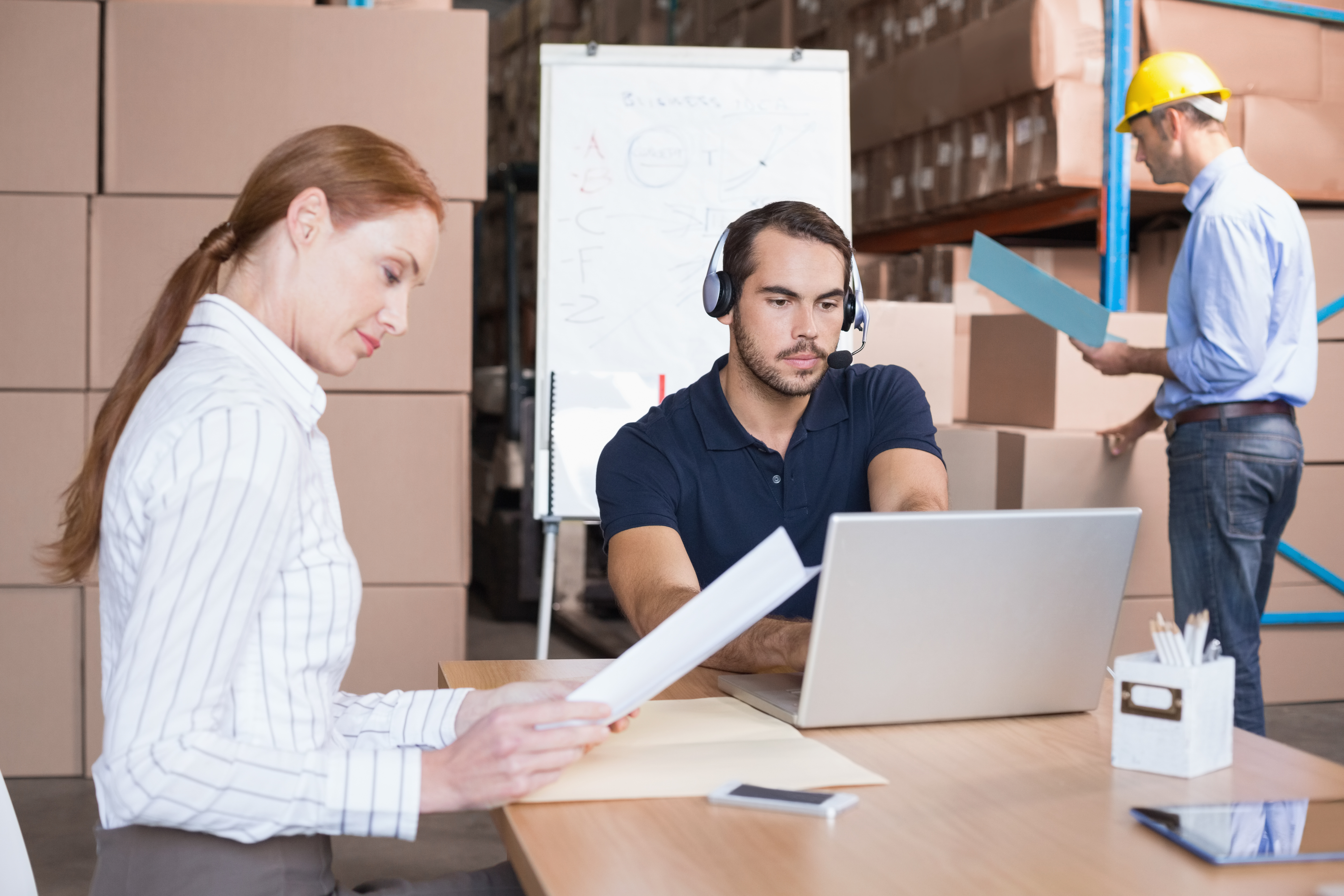 Three employees working in the inventory
