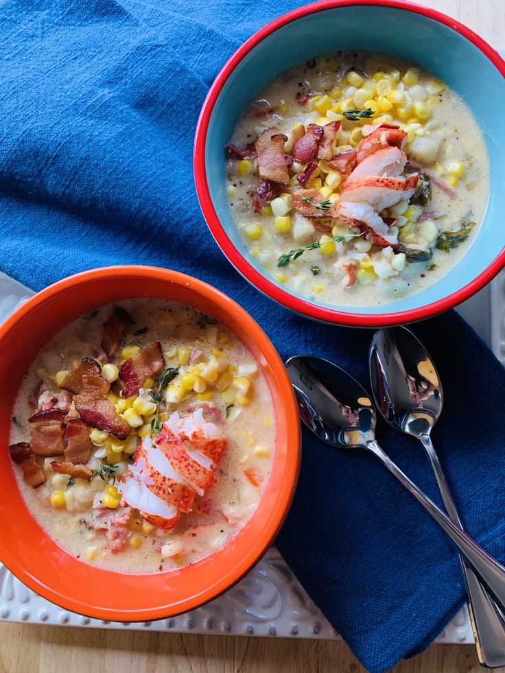 Two bowls of Lobster & Corn Chowder with two spoons