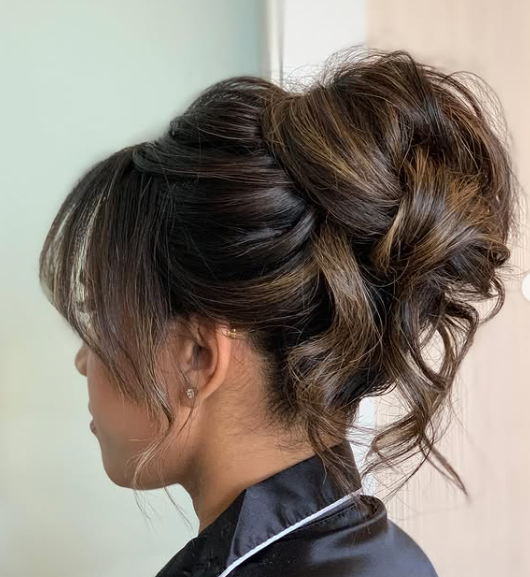person with hair styled in a voluminous updo