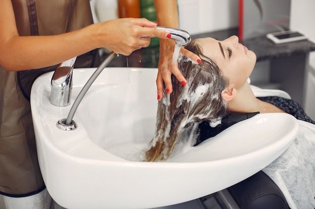 Stylist washing her client's hair