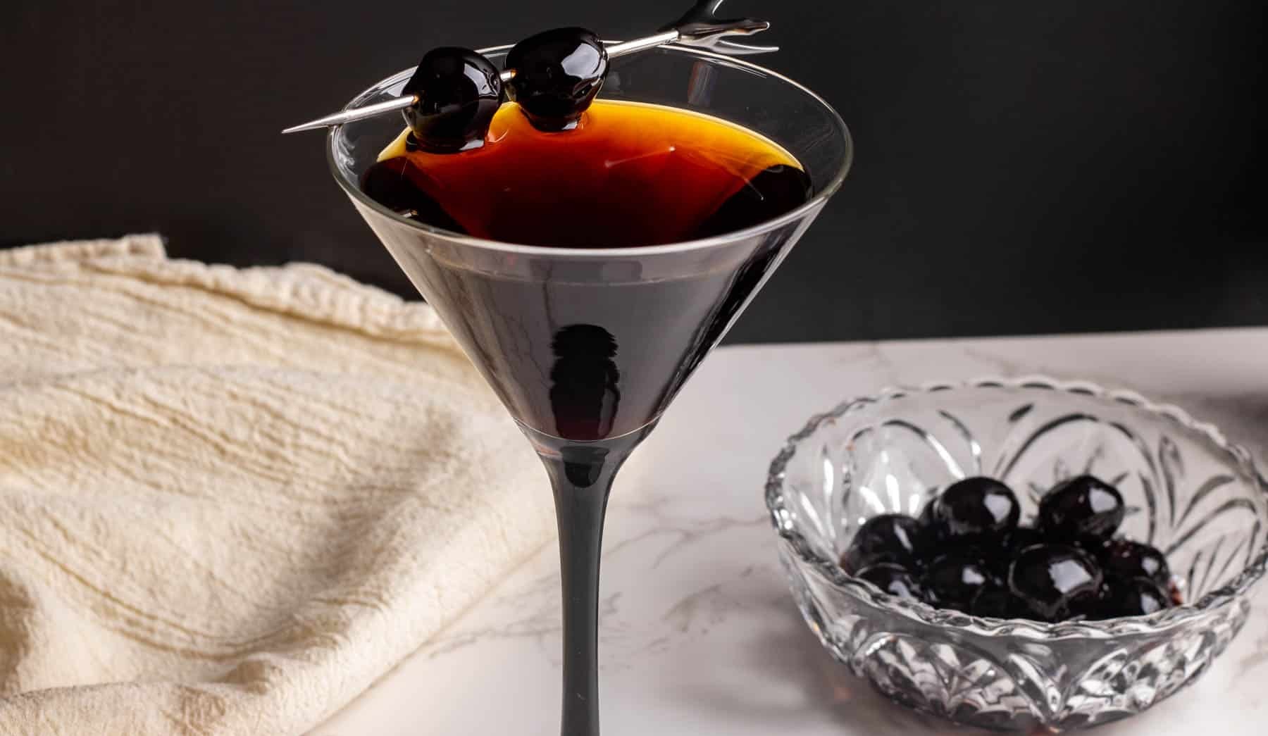 Dark Manhattan cocktail with cherry