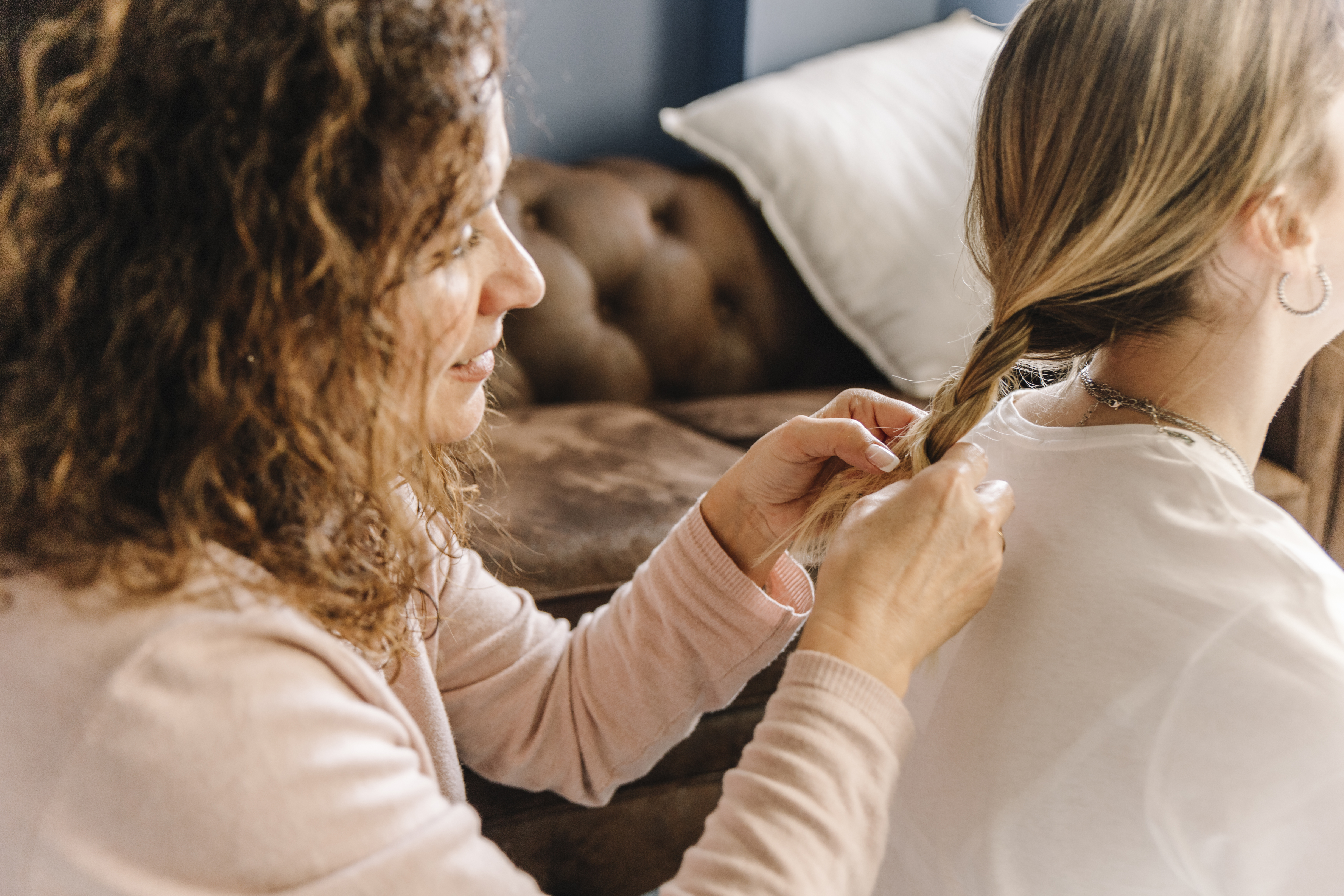 Woman braiding another woman’s hair