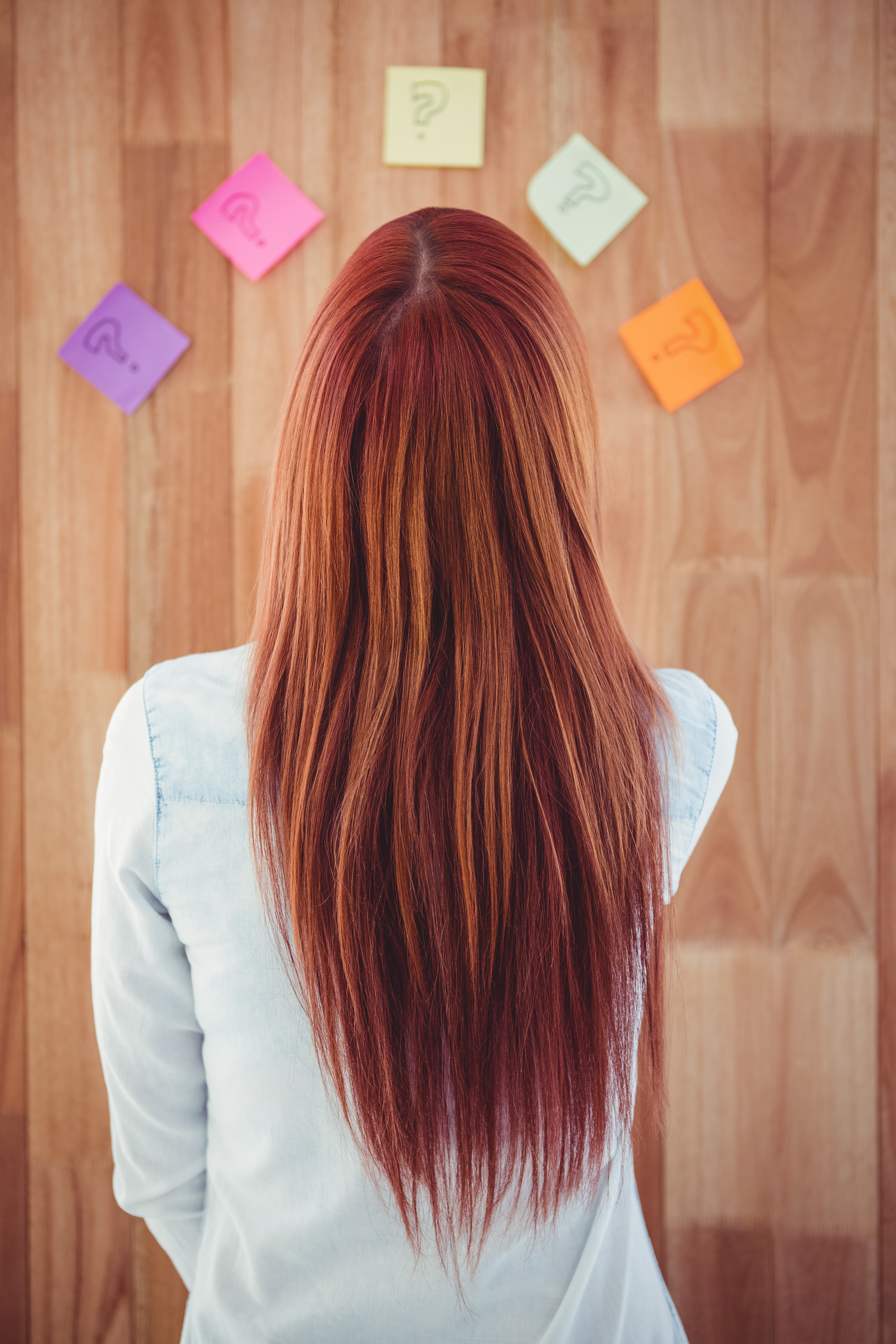 Woman with long red hair thinking