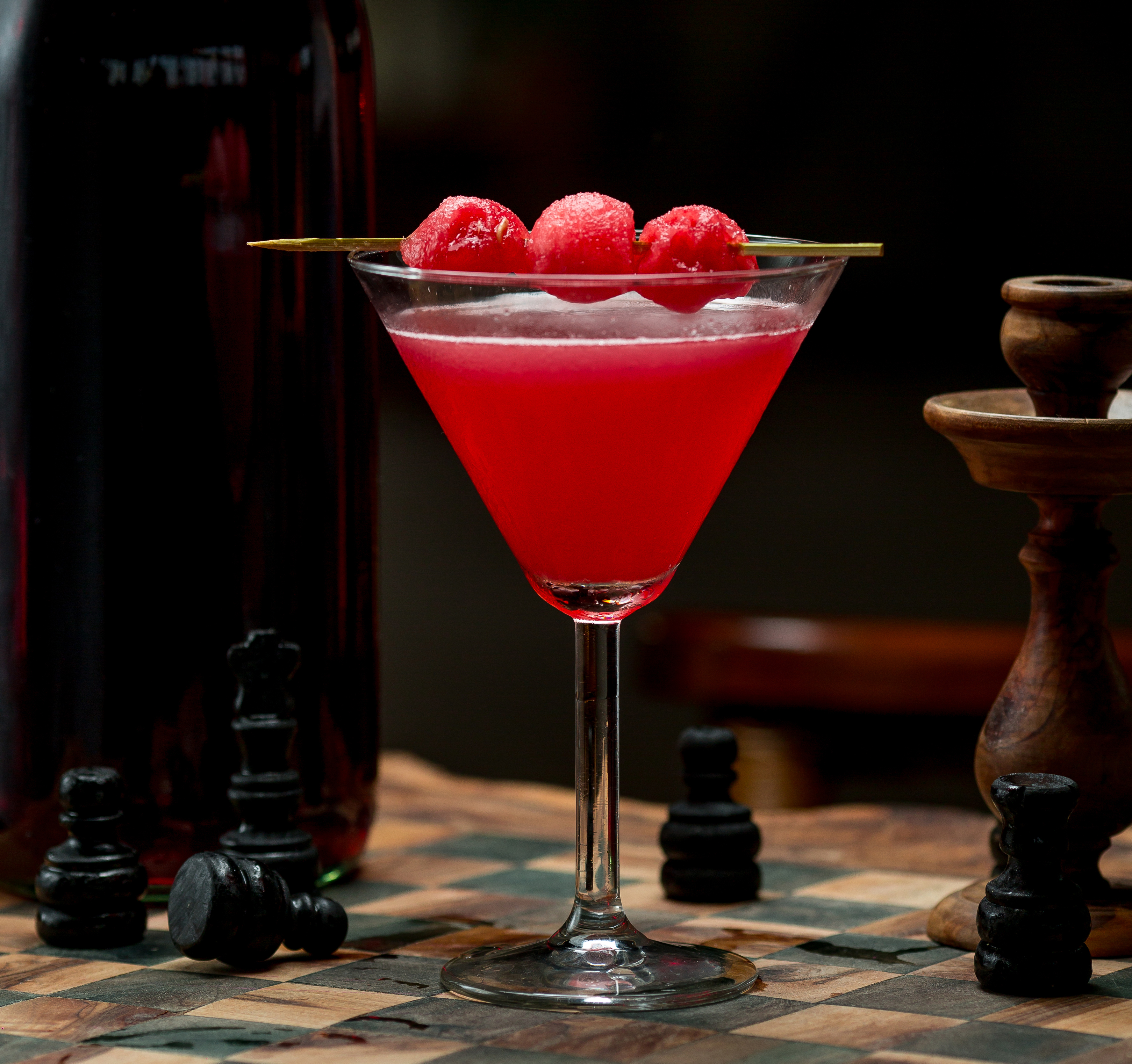 Pink cosmopolitan cocktail with lime wheel