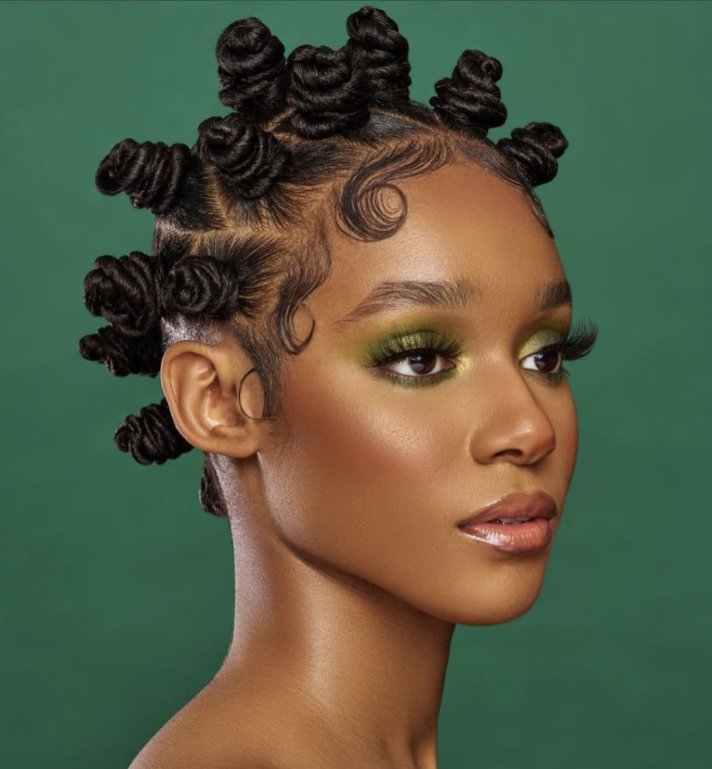 person with dark hair styled in bantu knots