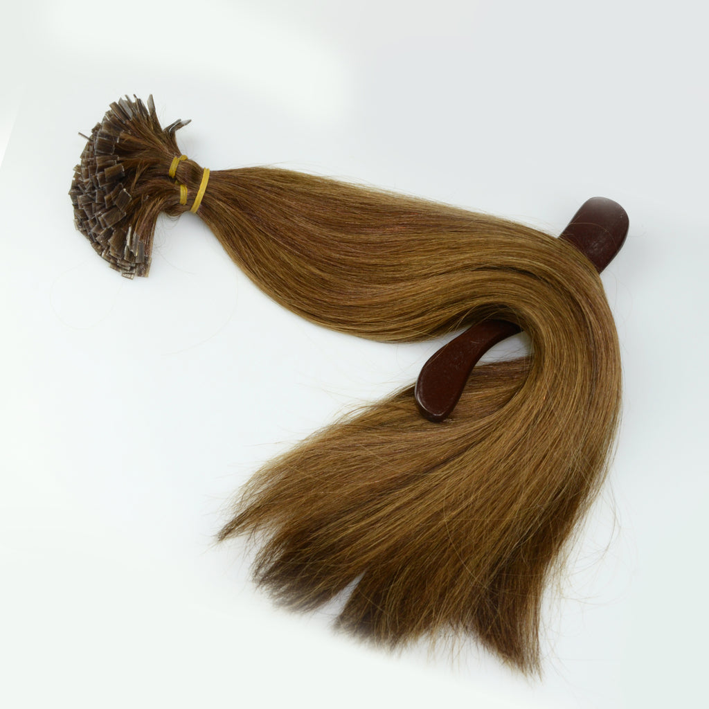 A bundle of brown keratin-tipped hair extensions