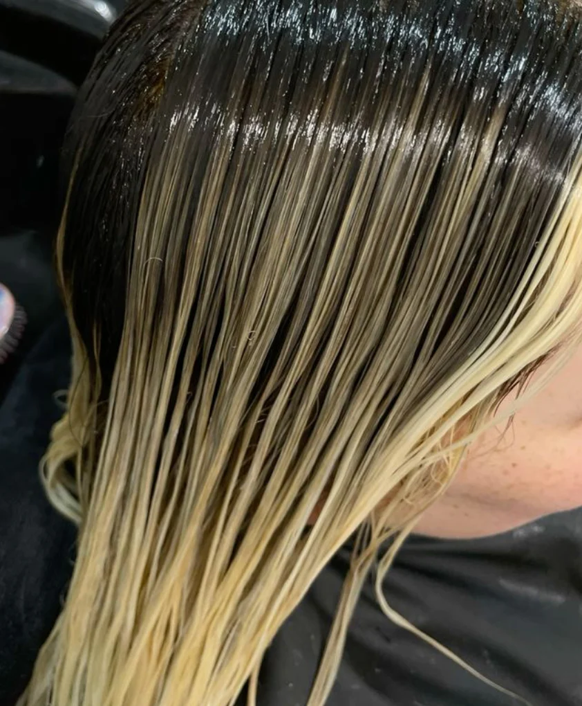 Wet bleached hair roots visible