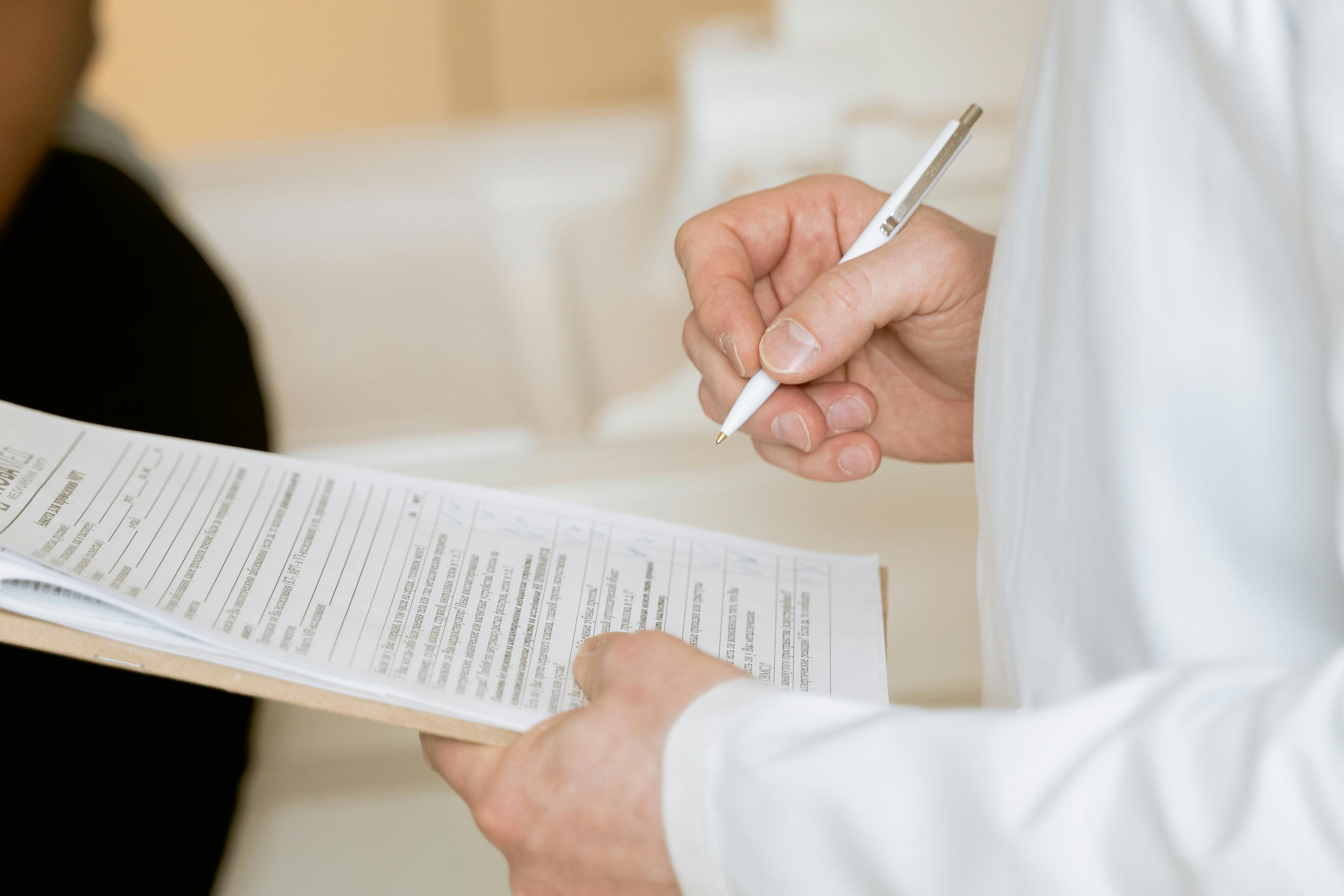 Royal Wound Care staff member filling out a patient treatment form on a clipboard, ensuring accurate documentation and personalized care planning. Royal Wound Care staff member filling out a patient treatment form on a clipboard, ensuring accurate documentation and personalized care planning.